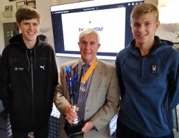 Vice President Clive presenting the trophy to Joe (left) and George (right)